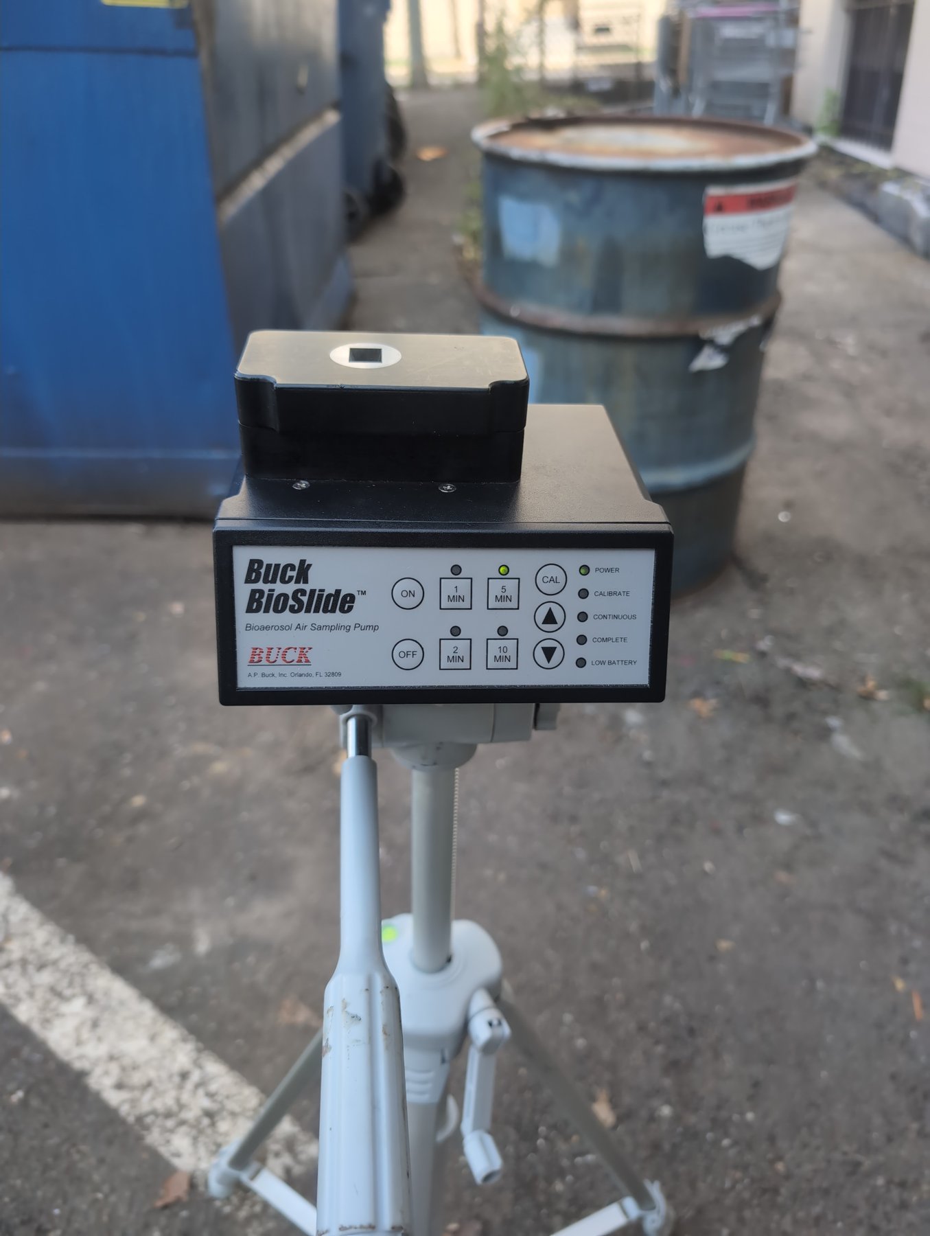 Buck BioSlide spore trap air sampling pump set up outdoors for an outdoor control sample during a mold inspection