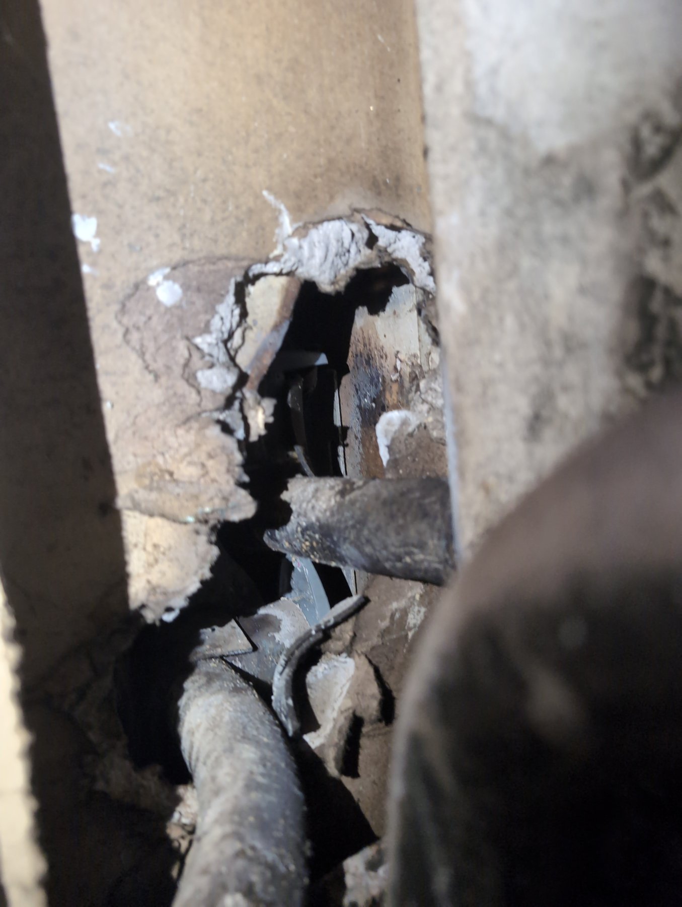 Damaged asbestos-containing pipe insulation on a boiler line, the kind of material sampled during an asbestos inspection
