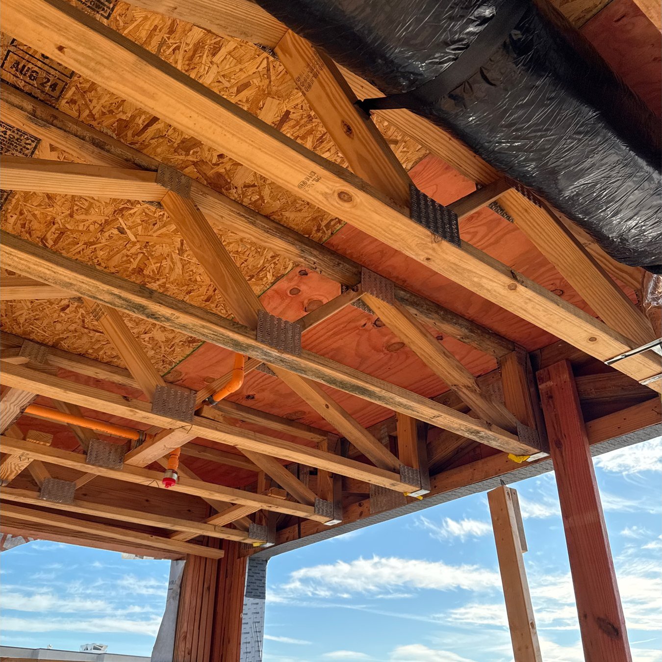 Roof trusses open to the sky at The Chasen Apartments construction site in Richmond, Virginia