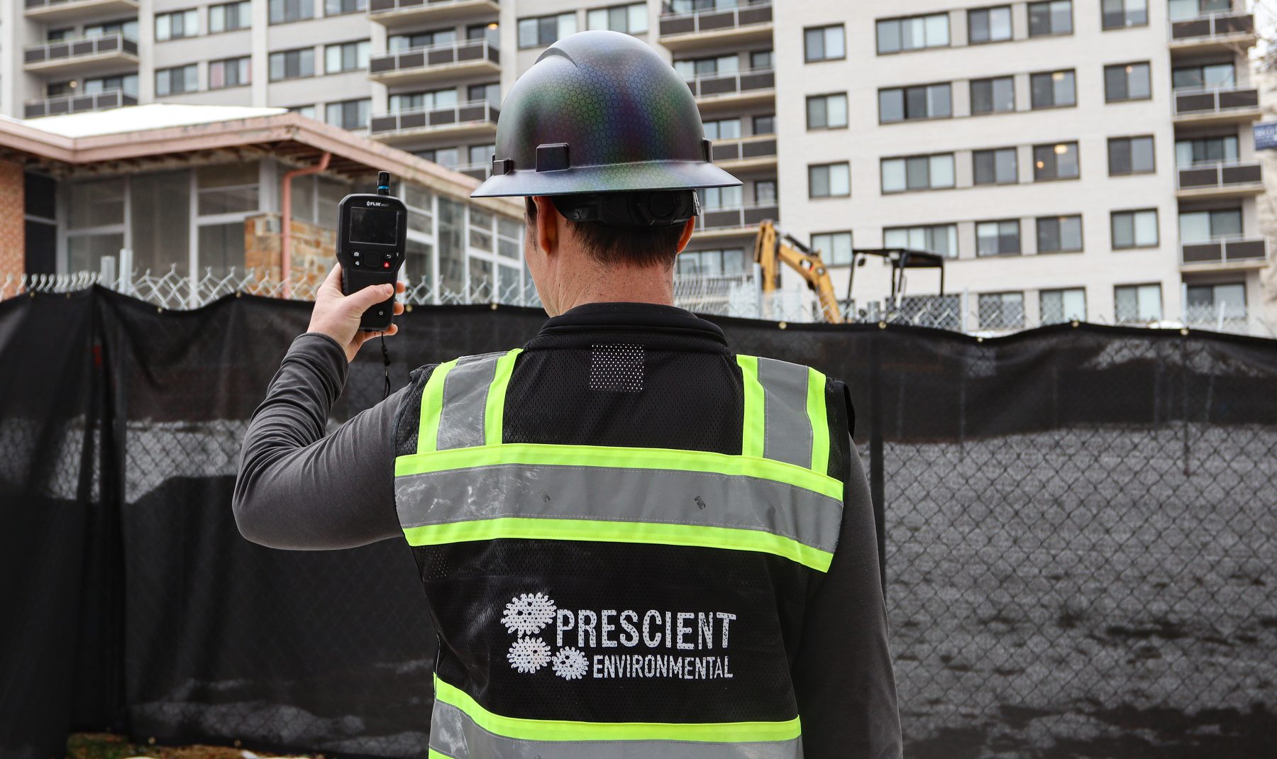 Prescient Environmental inspector documenting the exterior of a mid-rise building