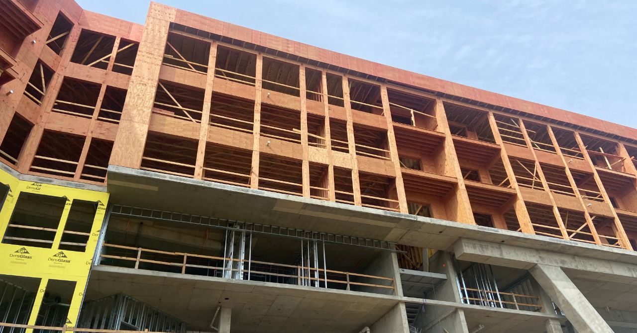 One Rangers Way under construction, wood framing visible on upper floors