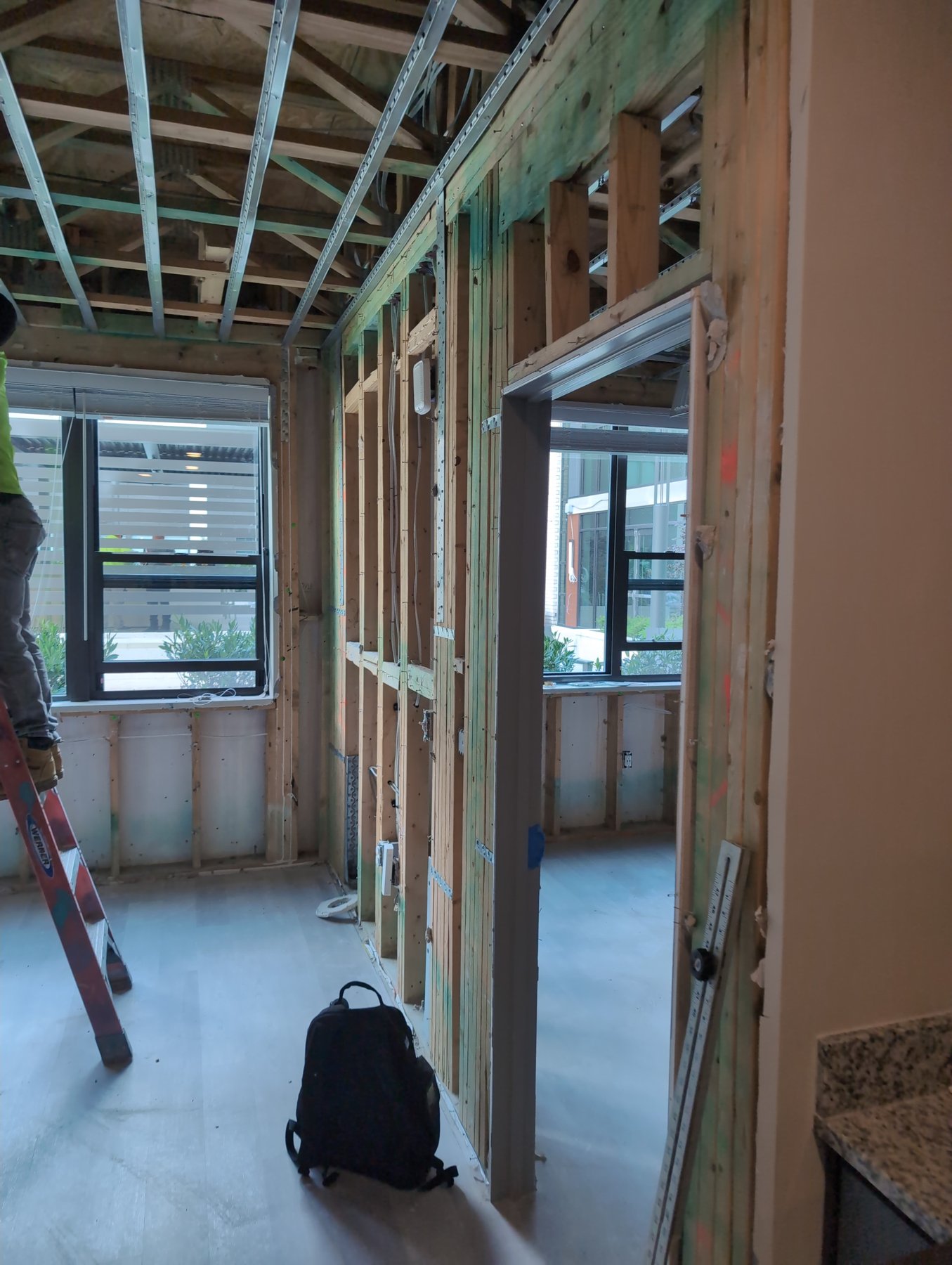 Student apartment at One University stripped to the framing with windows during a mold and moisture inspection