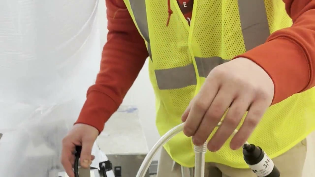 Technician setting up air sampling pumps for an asbestos final clearance