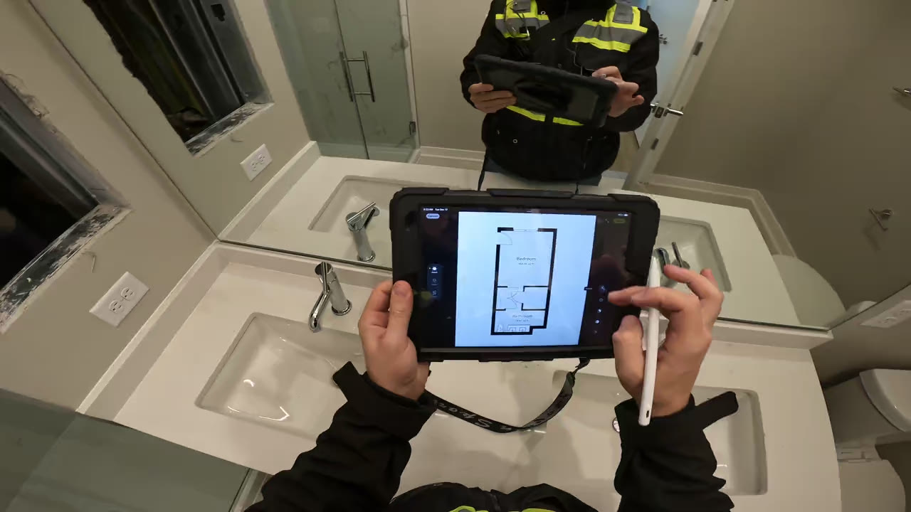 Inspector drawing a moisture map on a tablet during an inspection