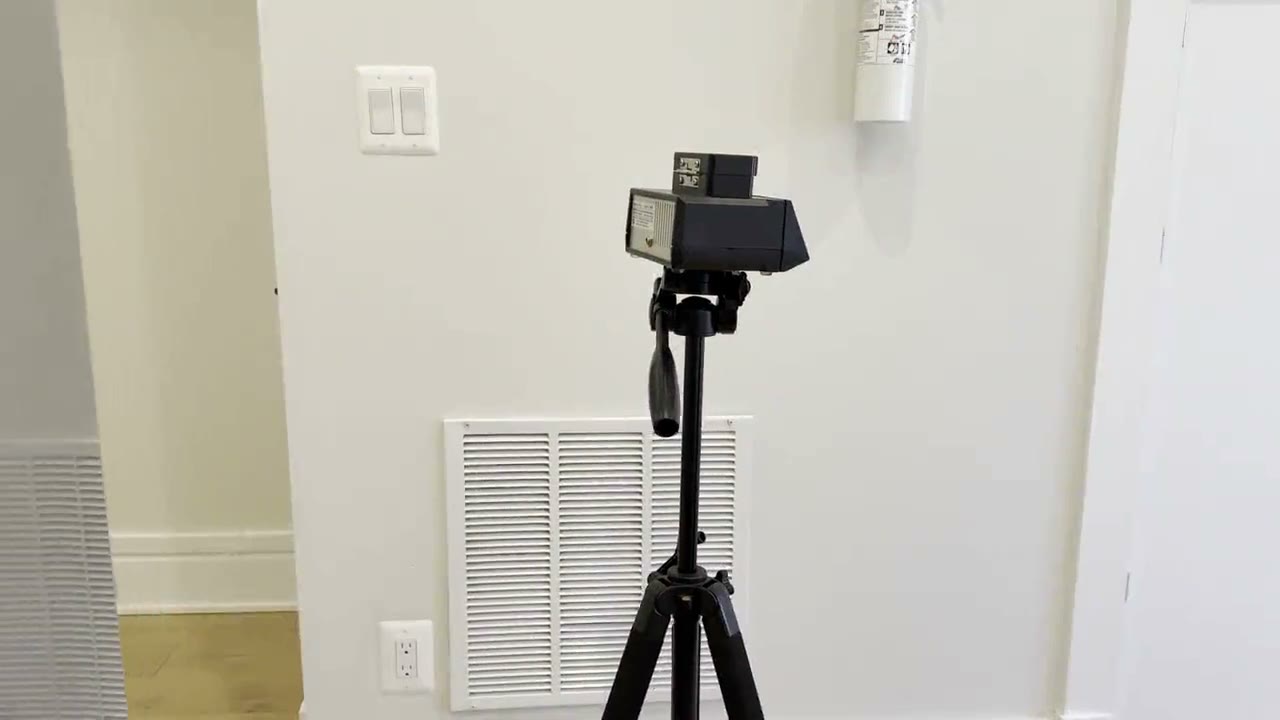 Spore trap air sampler on a tripod in an empty unit during clearance testing